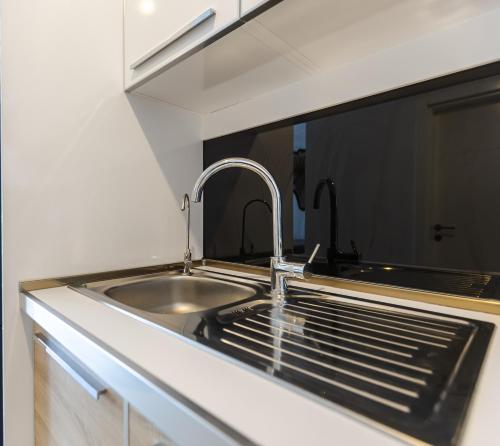 a kitchen with a sink and a faucet at Magnificent Diamond Duplex in Tbilisi City
