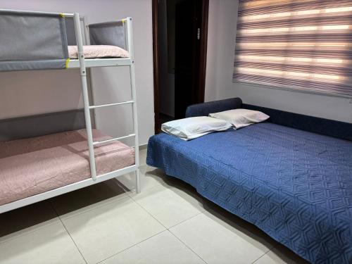 Llit o llits en una habitació de Perfect House 2