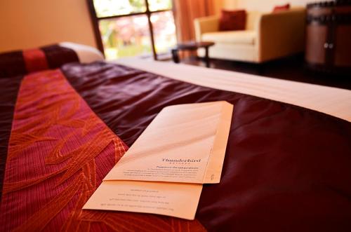 a hotel room with a plaque on a bed at Thunderbird Resorts - Rizal in Binangonan