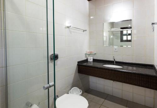 a bathroom with a toilet and a sink at Pousada Camury in Garuva