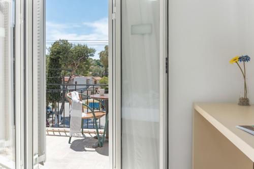a sliding glass door with a view of a balcony at Ilias Voula Studios in Panormos Kalymnos