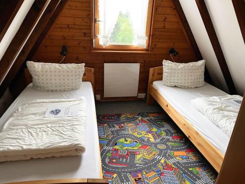 two beds in a small room with a window at Ferienhaus Bayern in Siegsdorf
