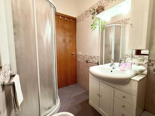 a white bathroom with a shower and a sink at La Casa di LiLi in Pontassieve