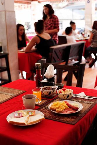 a table with a red table cloth with food on it at Lotus Friendly Hotel in Chaweng