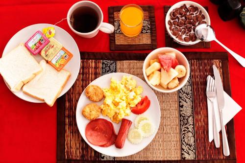 a table with plates of breakfast food and a cup of coffee at Lotus Friendly Hotel in Chaweng