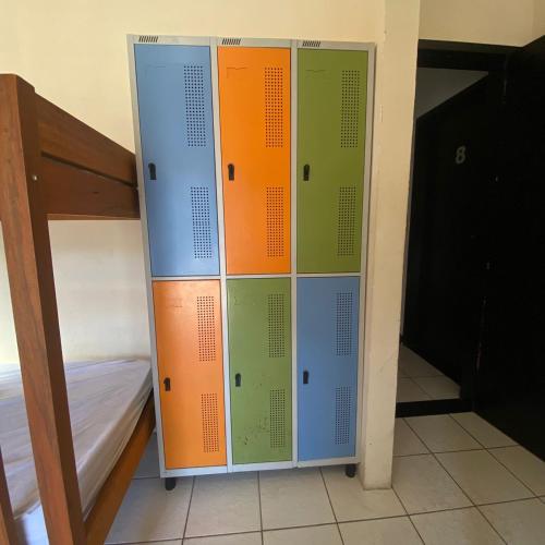 a row of lockers in a room next to a bunk bed at Hostel ABC in Angra dos Reis