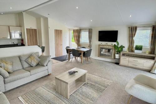 a large living room with a couch and a table at Sea Breeze Villa near to Newquay sleeping 6 guests in Newquay