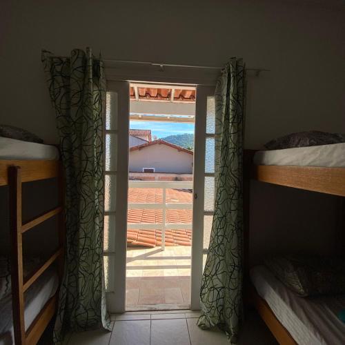 a room with a door open to a bedroom with bunk beds at Hostel ABC in Angra dos Reis