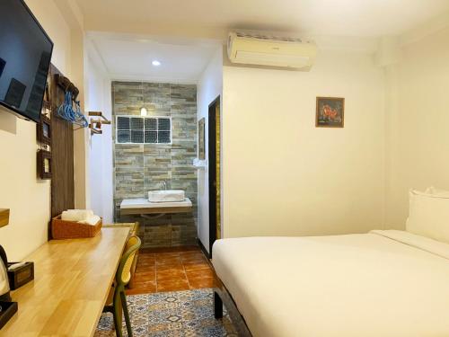 Postel nebo postele na pokoji v ubytování Somwang Boutique Hotel
