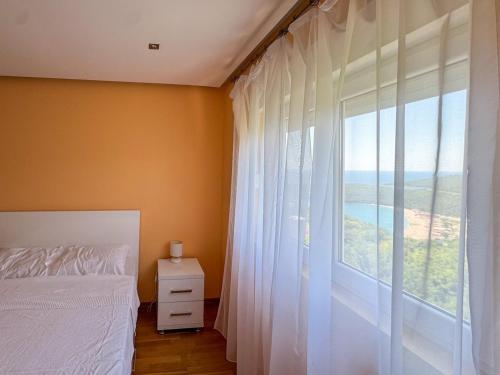 a bedroom with a bed and a large window at One-bedroom Apart, with panoramic view, Prijevor in Prijevor