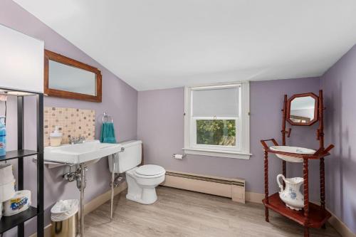 a bathroom with a toilet and a sink and a window at 66 Stetson Street Hyannis- Hyannis Haven in Hyannis