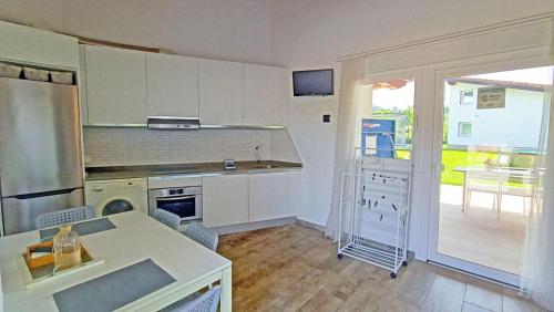a kitchen with white cabinets and a counter top at Casa Rural Txokoetxe in Mungia