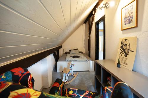 a small room with a bed in a room at Vila Republika in Malá Skála