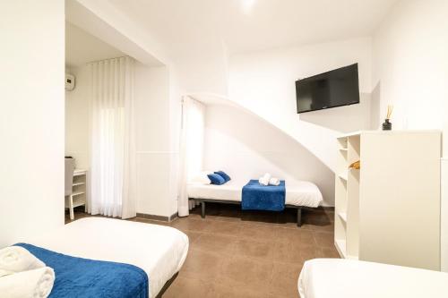 Posteľ alebo postele v izbe v ubytovaní Laramond Barcelona Rooms