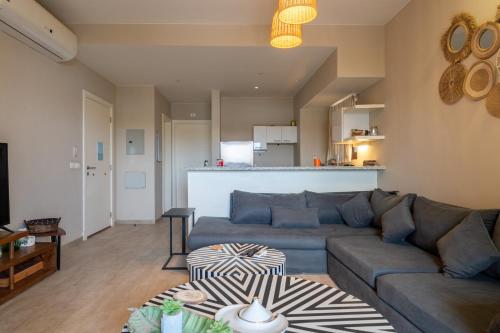 a living room with a couch and a kitchen at El Gouna - BIRD NEST in Hurghada