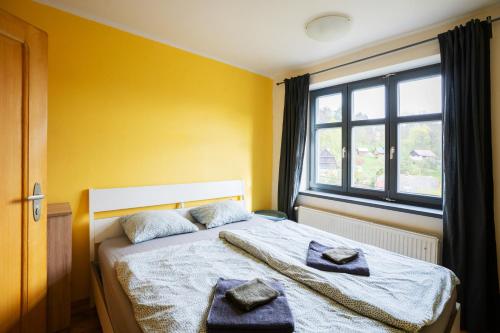 a bedroom with a bed with two towels on it at Vila Republika in Malá Skála