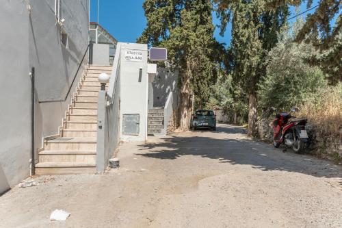 a red motorcycle parked on the side of a building at Ilias Voula Studios in Panormos Kalymnos