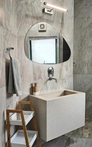a bathroom with a sink and a mirror at The Waves Beachfront Stay - Gleneagles in Ballito