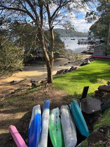 a group of surfboards lined up on the beach at Sydney Northern Beaches Waterfront Pittwater Avalon Beach - Clareville in Clareville