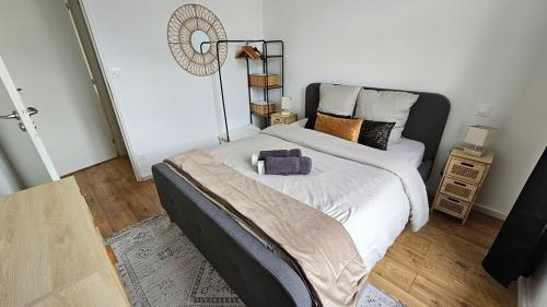 a bedroom with a large bed and a fan at Elegant apartment in a luxury residence in Arras