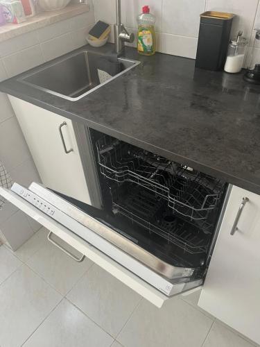 a kitchen with a sink and an oven in it at Apartman Foz Lagoon in Foz do Arelho