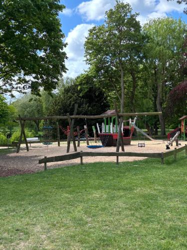 a playground in a park with a play equipment at Duke-Fewo am Meer im Haus Atlantic beim Kurpark in Grömitz