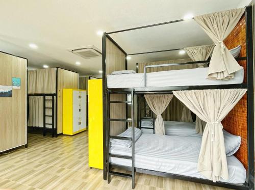 a group of bunk beds in a room at LOCA Hostel Phu Quoc in Phu Quoc