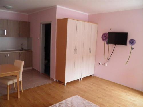 a living room with a white cabinet and a table at B&B Zmajevo Gnezdo 021 in Sremska Kamenica