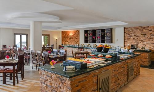 a buffet in a restaurant with a table and chairs at Aura Resort Sidi Abd El Rahman El Alamein in Sīdī ‘Abd ar Raḩmān