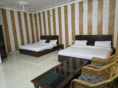 Ένα ή περισσότερα κρεβάτια σε δωμάτιο στο Hotel Vasundhara Palace