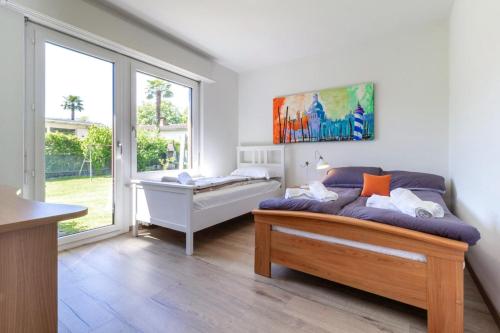a living room with a couch and a window at Oasi del Ticino in Magliaso