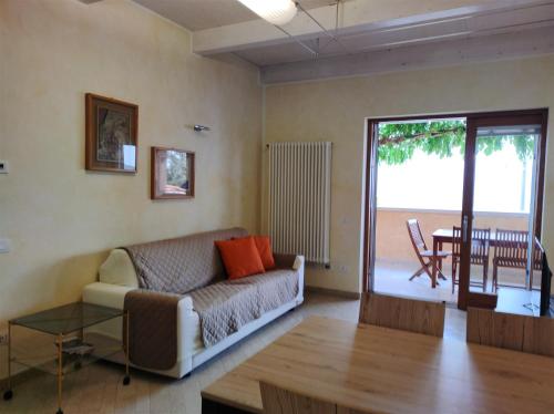 a living room with a couch and a table at IseoLakeRental - Casa Glicine in Sarnico