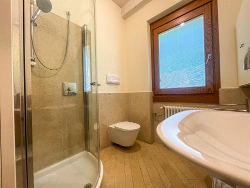 a bathroom with a shower and a toilet and a sink at IseoLakeRental - Casa Glicine in Sarnico
