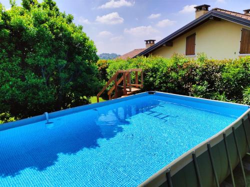 a large blue swimming pool in a yard at IseoLakeRental - Casa Glicine in Sarnico