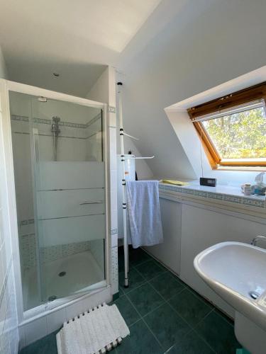 une salle de bain avec une douche en verre et un lavabo dans l'établissement Ref 010 Port-Navalo Maison pour onze personnes avec jardin, à Arzon