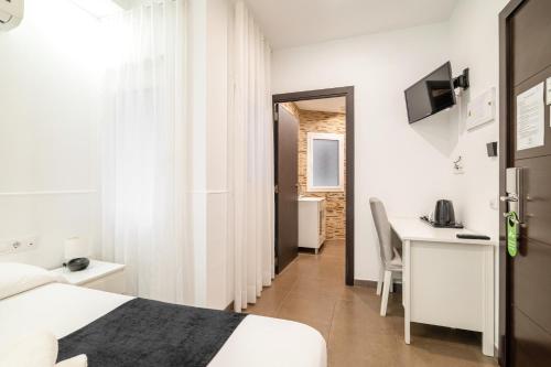 Televízia a/alebo spoločenská miestnosť v ubytovaní Laramond Barcelona Rooms