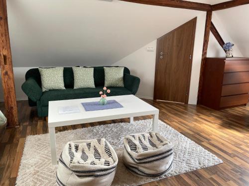 a living room with a couch and a coffee table at Penzion Agape in Luhačovice