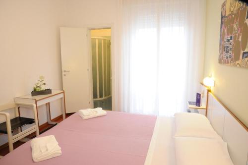 a bedroom with a bed with two towels on it at Hotel dell'Amarissimo in Bellaria-Igea Marina