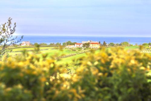 a view of a golf course with houses in the distance at Villa Gialla in Porto Recanati