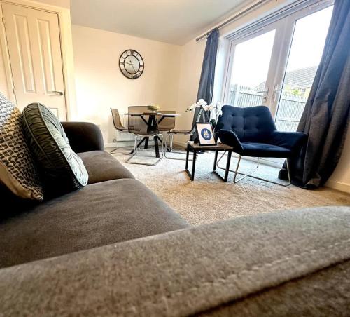 a living room with a couch and a table and a window at Whessoe House by Blue Skies Stays in Stockton-on-Tees