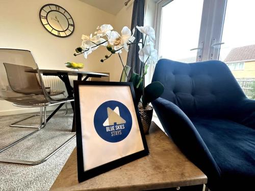 a living room with a blue chair and a table at Whessoe House by Blue Skies Stays in Stockton-on-Tees