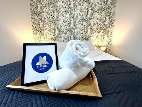 a towel sitting on a tray on a bed at Whessoe House by Blue Skies Stays in Stockton-on-Tees
