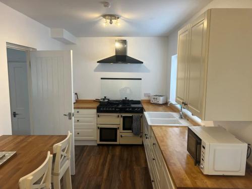 a kitchen with a sink and a stove top oven at Cotswold House in Stockton-on-Tees