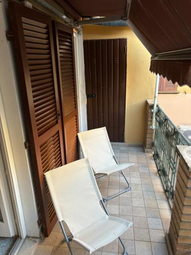 two white chairs sitting on a balcony at XX Settembre 43 n2 in Fano