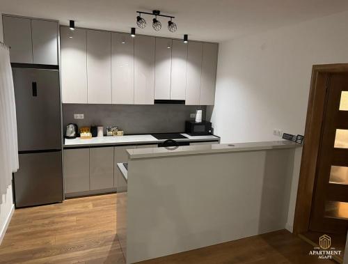 a kitchen with white cabinets and a counter top at Apartment Agape in Posušje