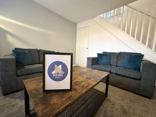 a living room with two couches and a table at Beck House by Blue Skies Stays in Middlesbrough