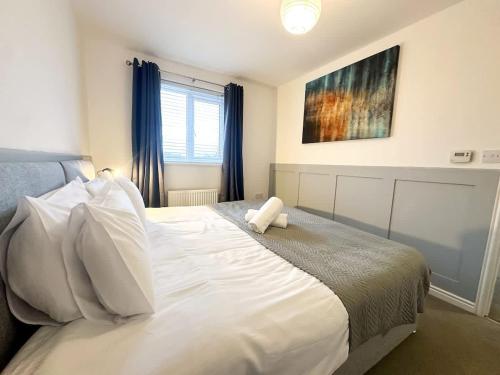a bedroom with a white bed with a teddy bear on it at Beck House by Blue Skies Stays in Middlesbrough
