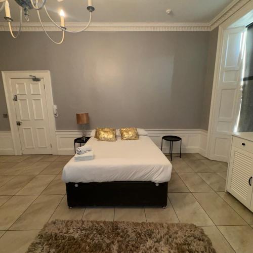 a bedroom with a bed with two pillows on it at Spacious Double Room In The Heart Of Edinburgh in Edinburgh