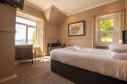 a bedroom with a large bed and a window at Dalrigh House in Oban