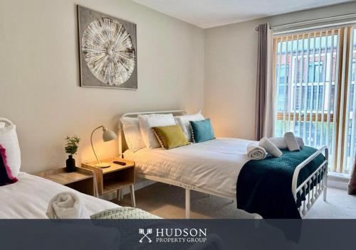 ein Schlafzimmer mit zwei Betten und einem Fenster in der Unterkunft 2-Bedroom Central Apartment in Lawley Bank